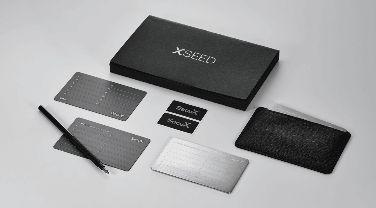 SecuX X-SEED kit contents with box, seed plates, engraver, tamper-proof stickers and protective case