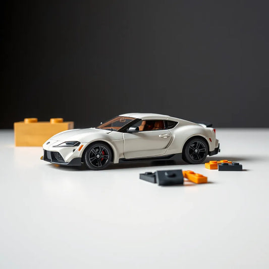 Detailed toy model of a Toyota Supra on a tabletop with LEGO pieces and neutral studio lighting