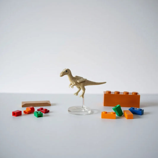 LEGO Baby Pteranodon model on a clean tabletop with a small display stand and extra bricks nearby