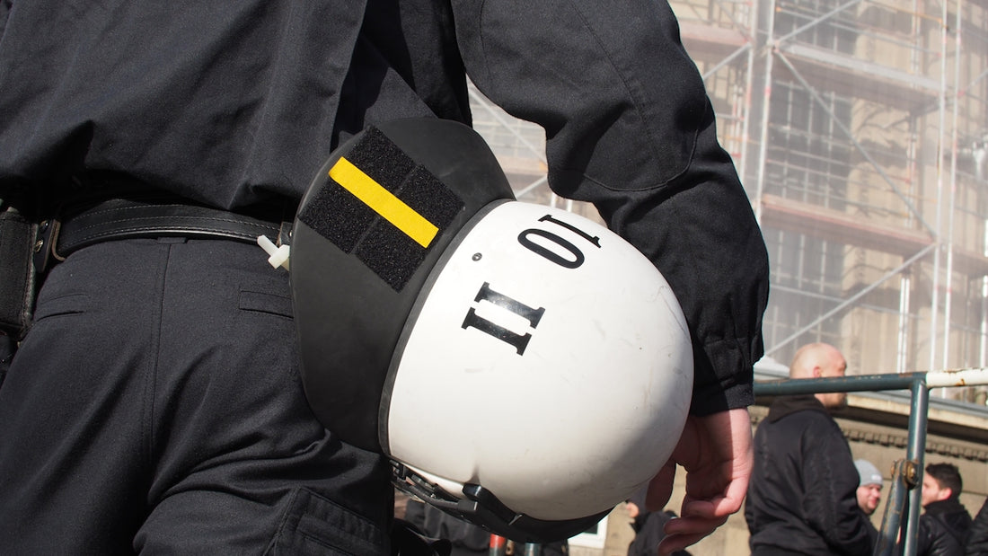 a police officer is holding a white helmet