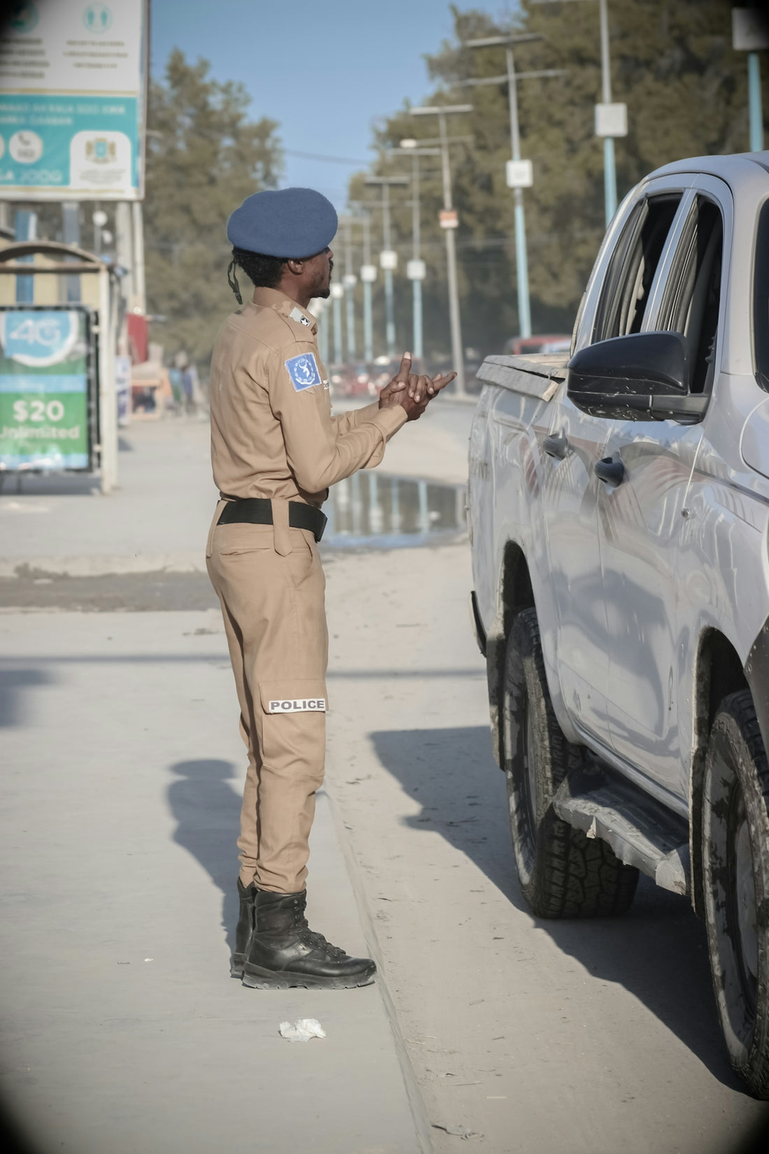a police officer standing next to a white truck