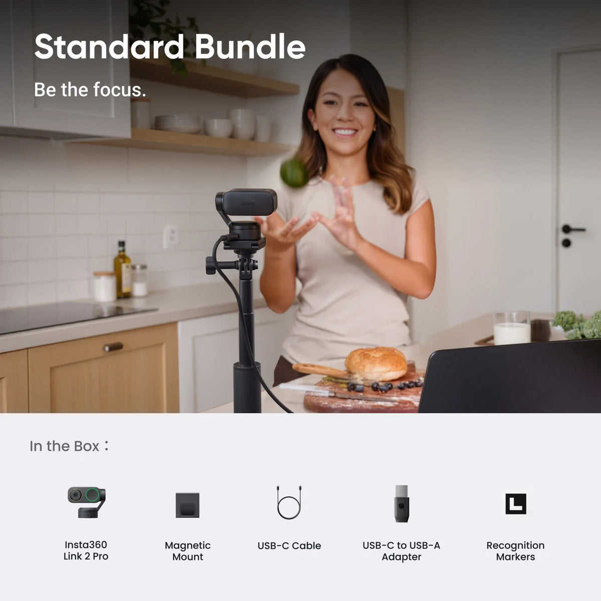 Insta360 Link 2 Pro Standard Bundle lifestyle shot with the in-the-box contents: camera, magnetic mount, USB-C cable, USB-C to USB-A adapter and recognition markers
