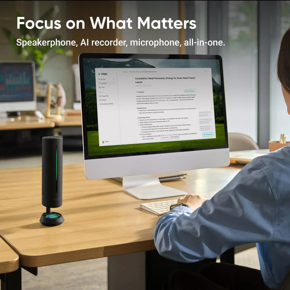 Insta360 Wave on a desk beside a monitor showing a live meeting transcript