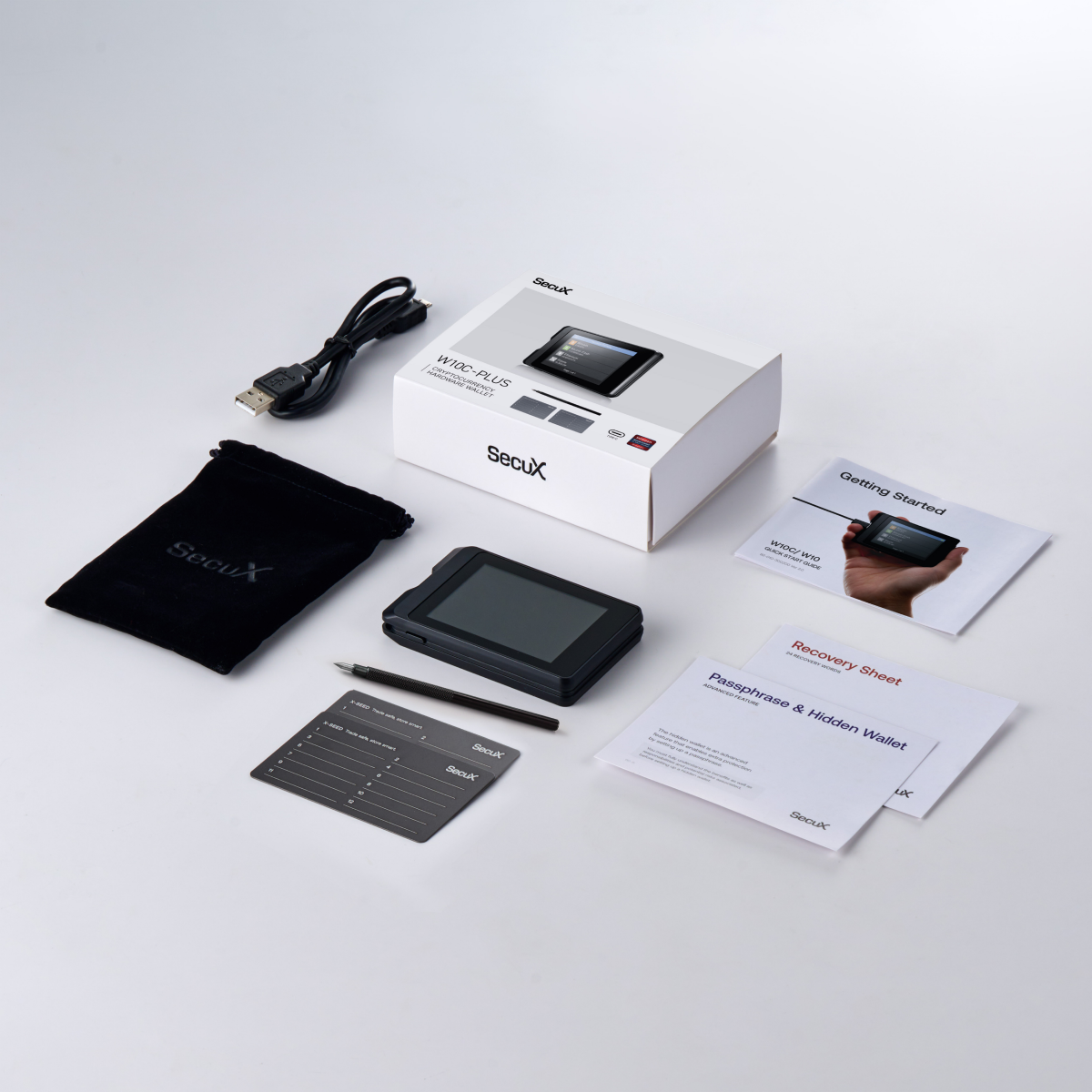 SecuX W10C-PLUS box contents: wallet, USB cable, black pouch, engraver, two aluminium X-SEED plates, recovery sheet and quick start guide