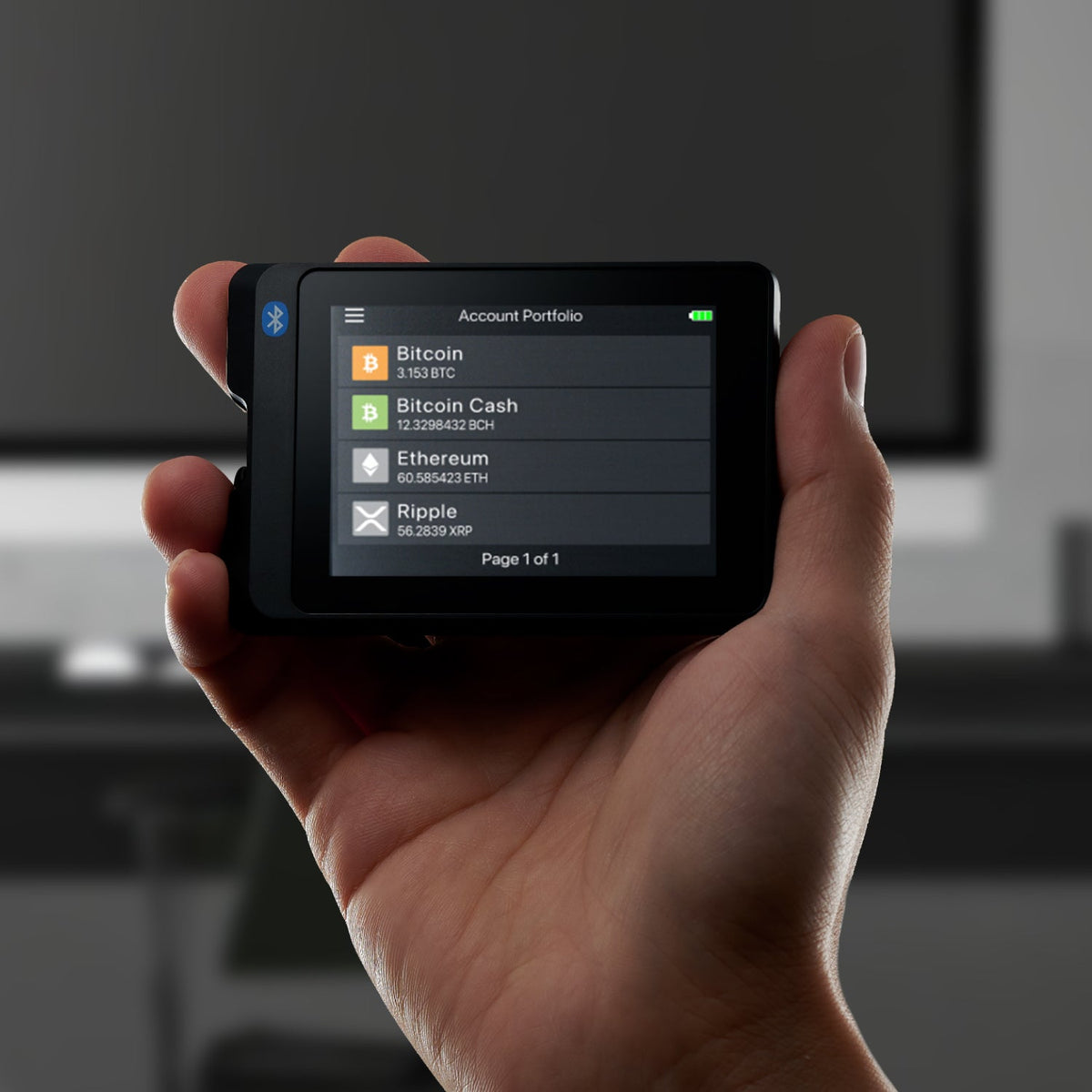 SecuX W20C-PLUS held in one hand with the account portfolio on its touchscreen