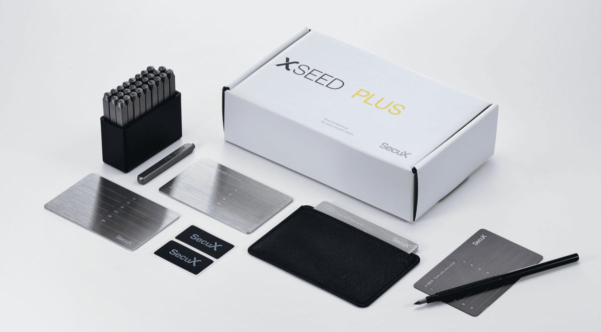SecuX X-SEED Plus kit contents with box, steel punch set, seed plates, engraver, tamper-proof stickers and protective case