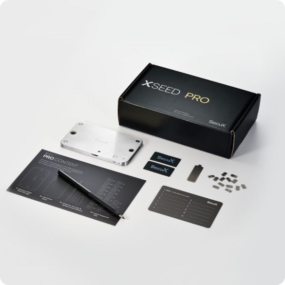 SecuX X-SEED PRO kit contents with box, steel seed storage, letter tiles, turn key, aluminium plate, engraver and tamper-proof stickers