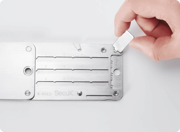 Turn key locking the frame screw of the SecuX X-SEED PRO seed storage